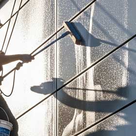 Eingeschäumte Fassadenfläche wird mit Wischgummi abgezogen